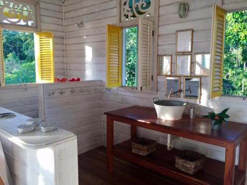 a bathroom with a sink and two windows at Lima Limón Eco-House in Bocas del Toro