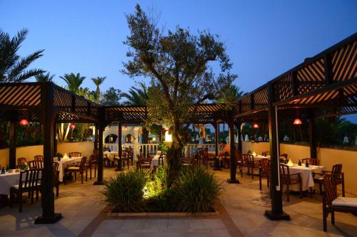 a restaurant with tables and chairs in a patio at The Residence Tunis in Gammarth