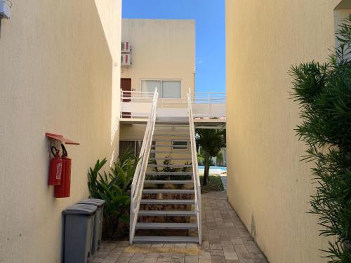 a stairway leading up to a building with a stair case at Loft Solar Água in Pipa