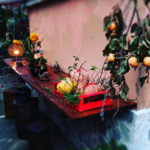 a table with fruits and plants on a wall at Petalo Rosso b&b in Lenola