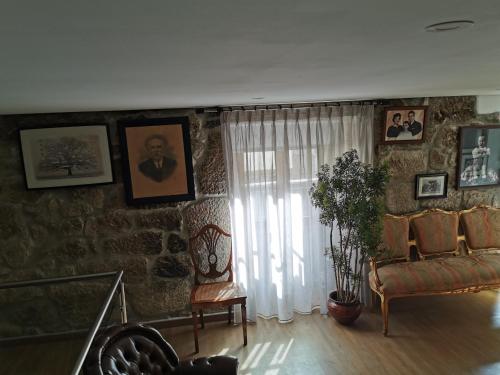 a living room with a couch and a window at Isabel do Couto - casa de charme in Castro Daire