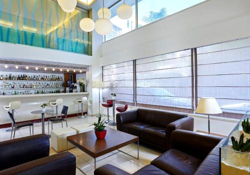 a living room with couches and a bar at Atrion Hotel in Heraklio