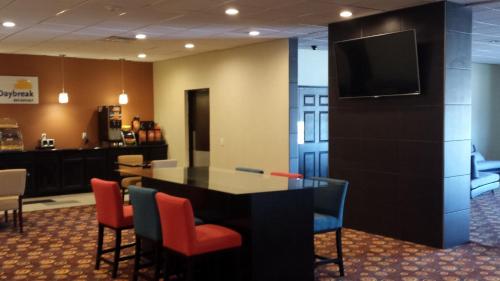 a conference room with a table and chairs and a television at Days Inn by Wyndham Henryetta in Henryetta