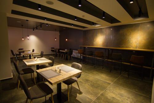 a restaurant with tables and chairs in a room at Victoria Inn Tbilisi in Tbilisi City