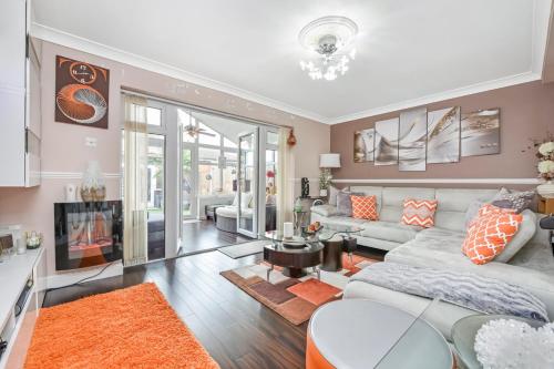 a living room with a couch and a table at Docklands Stay, Room in Modern Spacious House - Near Excel Centre, City Airport, UEL,Sleeps 2 in London