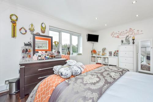a bedroom with a large bed and a dresser at Docklands Stay, Room in Modern Spacious House - Near Excel Centre, City Airport, UEL,Sleeps 2 in London