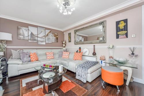 a living room with a couch and a table at Docklands Stay, Room in Modern Spacious House - Near Excel Centre, City Airport, UEL,Sleeps 2 in London
