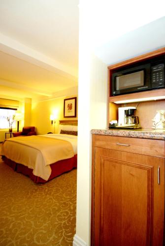 a hotel room with a bed and a microwave at San Carlos Hotel New York in New York
