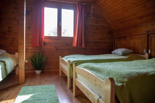 A bed or beds in a room at Körösparti wellness faház