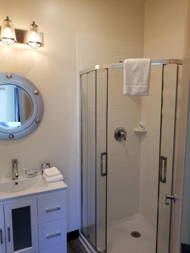 a bathroom with a shower and a sink at The Inn on Mount Desert in Bar Harbor