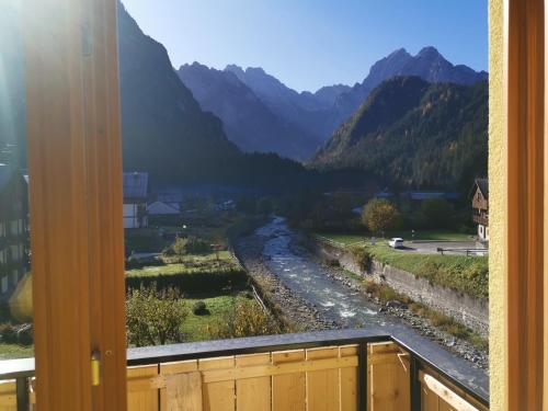 a view from a window of a river and mountains at All'Amicizia in Santo Stefano di Cadore