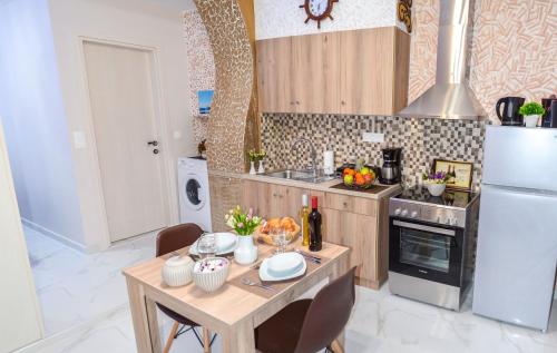 a small kitchen with a table and a refrigerator at Epaminontas Captain in Agia Galini