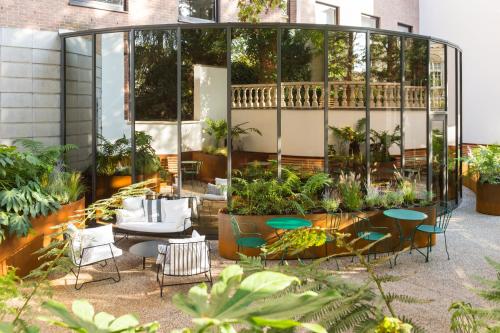
a garden filled with lots of plants and furniture at ibis Brussels Centre Chatelain in Brussels

