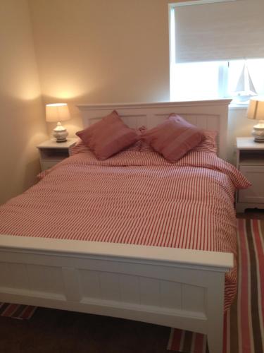 a bed with two pillows on it in a bedroom at Watchet Cottage in Watchet