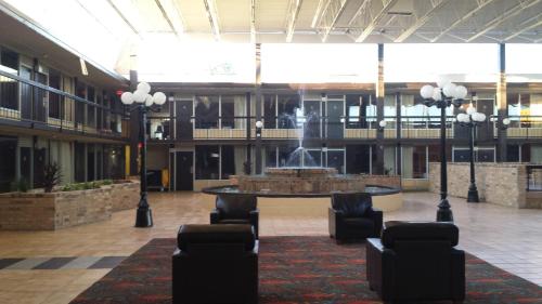 a lobby with a fountain in the middle of a building at Days Inn by Wyndham Henryetta in Henryetta