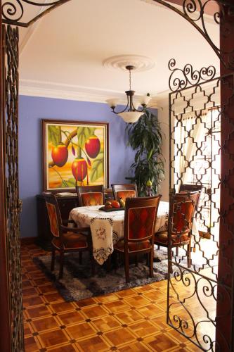 a dining room with a table and chairs at Casa Morisca/Moorish House in Bogotá