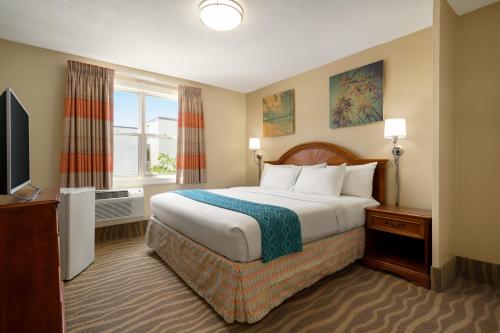 a hotel room with a bed and a television at Plim Plaza Hotel in Ocean City