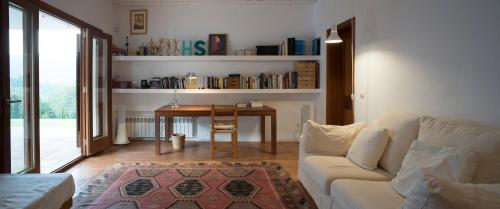 a living room with a couch and a table at Can Poeta in Sant Carles de Peralta
