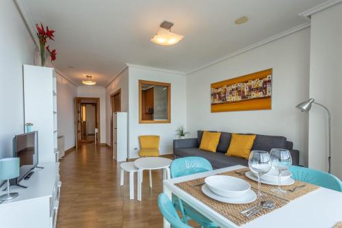 a living room with a couch and a table at Apartamentos Alocea in A Coruña