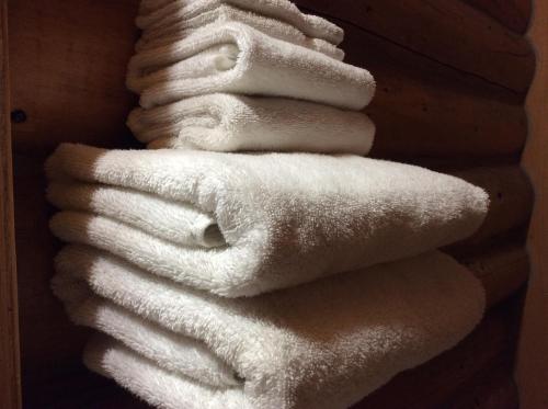 a stack of white towels on a wall at Double G Service in Muncho Lake