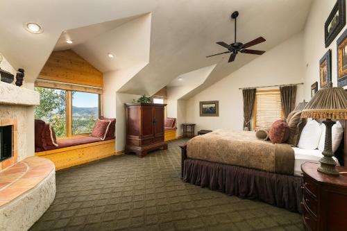 a large bedroom with a bed and a fireplace at Park City Homes by White Pines Solamere in Park City