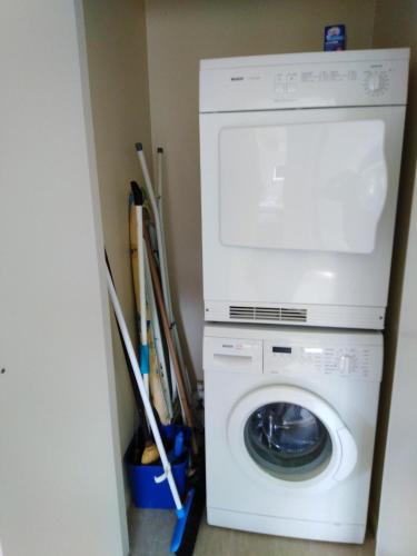 a washer and dryer in a laundry room at Whatuwhiwhi TOP 10 Holiday Park in Tokerau Beach