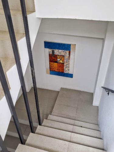 a staircase in a building with a painting on the wall at KASA The Lofts 201 HUGE 2 bed 2 bath for 6 Washer Dryer in San Juan