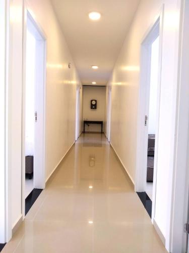 a hallway in a building with white walls and white floors at Pousada Pontal do Sul in Pontal do Paraná