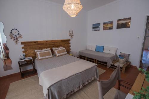 a bedroom with two beds and a couch in it at Casa do Mar - Nazaré in Nazaré