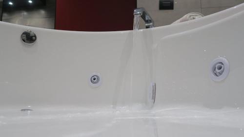 a white sink with two knobs on it at Motel Boutique Xpress in Ensenada