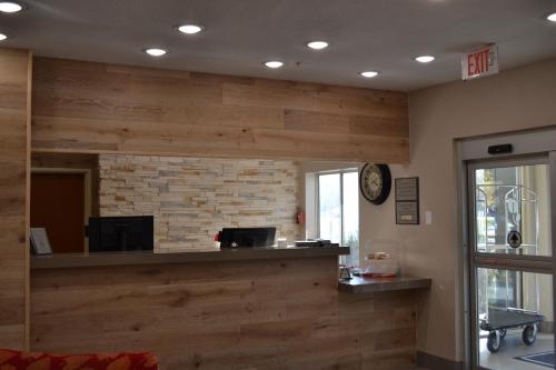 an office with wooden walls and a reception counter at Country Inn & Suites by Radisson, Fairview Heights, IL in Fairview Heights