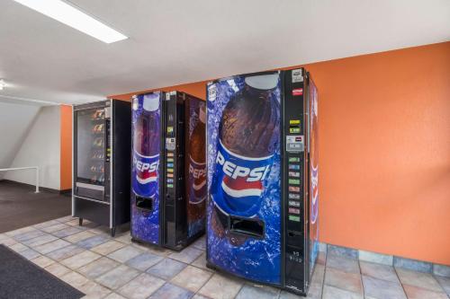 a row of pepsi vending machines in a room at Motel 6-Fargo, ND - West Acres - North Fargo in Fargo