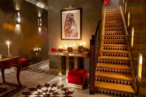 a living room with a staircase and a fireplace at Riad Touda in Marrakesh