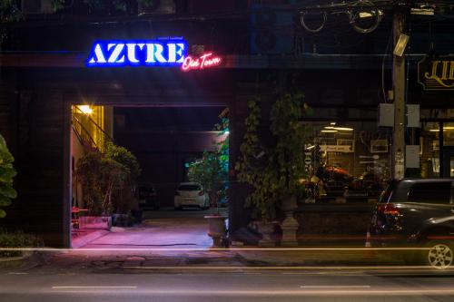 a neon sign for a appliance store at night at Azure Hostel Bangkok in Bangkok
