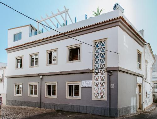 a white building with a lot of windows at DREAMS HOUSE in Faro