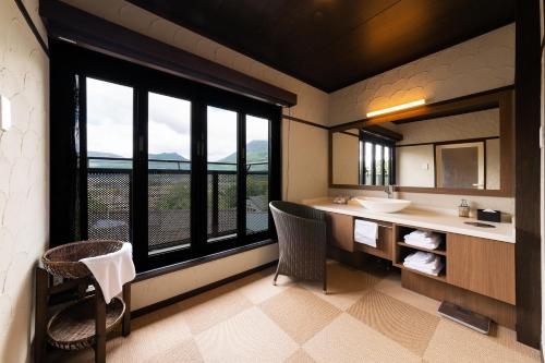 a bathroom with a sink and a large window at Yufudake Ichibo no Yado Kirara in Yufuin