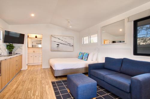 a small room with a bed and a couch at BIG4 Sandstone Point Holiday Resort Bribie Island in Bongaree