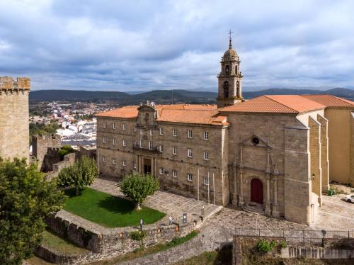 an old building with a clock tower on top of it at Parador de Monforte de Lemos in Monforte de Lemos