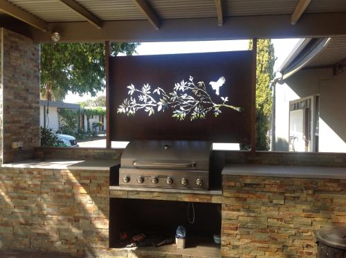 a outdoor oven with a painting on the wall at Cobram Colonial Motor Inn in Cobram