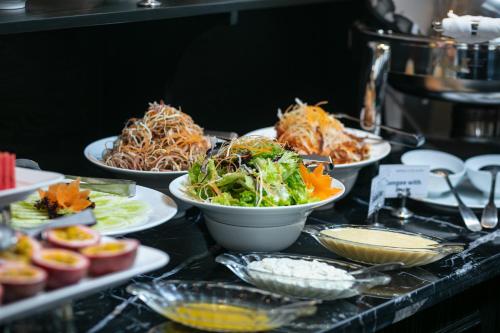 a buffet with plates of food on a table at Imperial Hotel & Spa in Hanoi