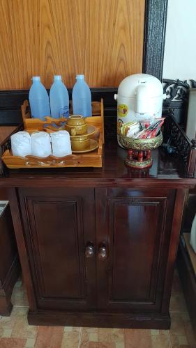 a wooden cabinet with plates and blue vases on it at Paradise Pearl Bungalows in Phi Phi Don