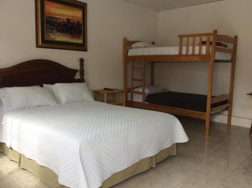 a bedroom with a bed and a bunk bed at Casa Blue Tortuga in Ballenita
