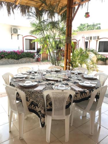 a table with white chairs and a black and white table cloth at Casa Blue Tortuga in Ballenita