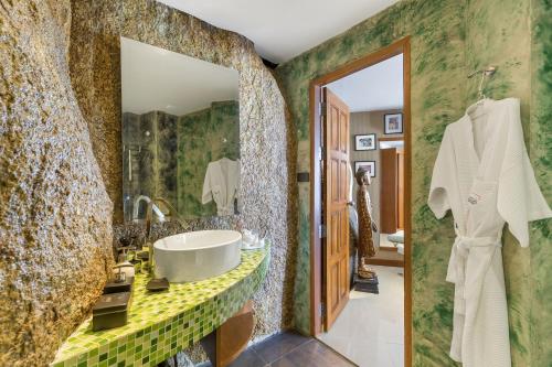 a bathroom with a large mirror and a sink at Beluga Boutique Hotel in Lamai