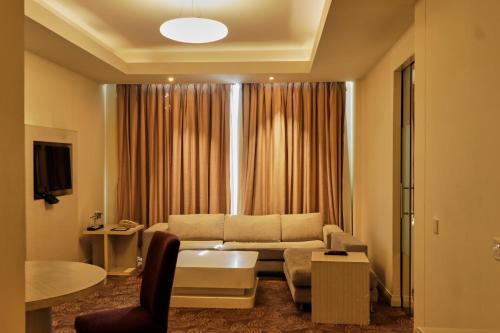 a living room with a couch and a table at Park Plaza Faridabad in Faridabad