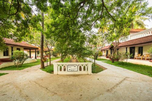 a sign sitting in the middle of a driveway at Mantra Koodam Kumbakonam - A CGH Earth Experience in Kumbakonam