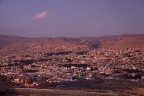 an aerial view of a city at night at Basant Villa in Wadi Musa