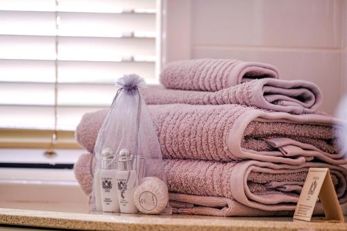 a pile of towels sitting on a counter in a bathroom at Valley View Bed and Breakfast in Newcastle