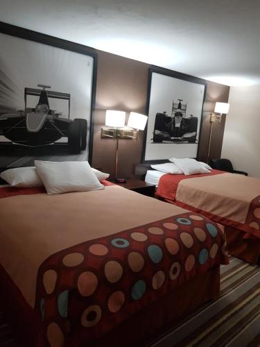 a hotel room with two beds and two lamps at Super 8 by Wyndham Shelton in Shelton