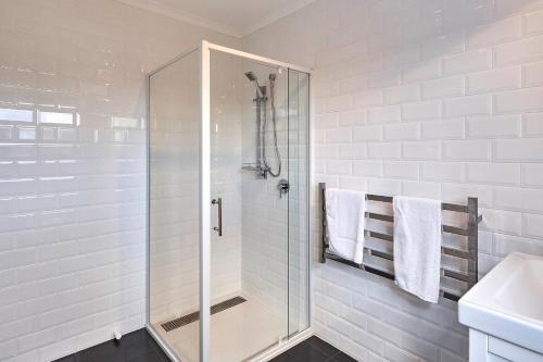 a shower with a glass door in a bathroom at DOLPHIN LOOKOUT COTTAGE - amazing views of the Bay of Fires in Binalong Bay